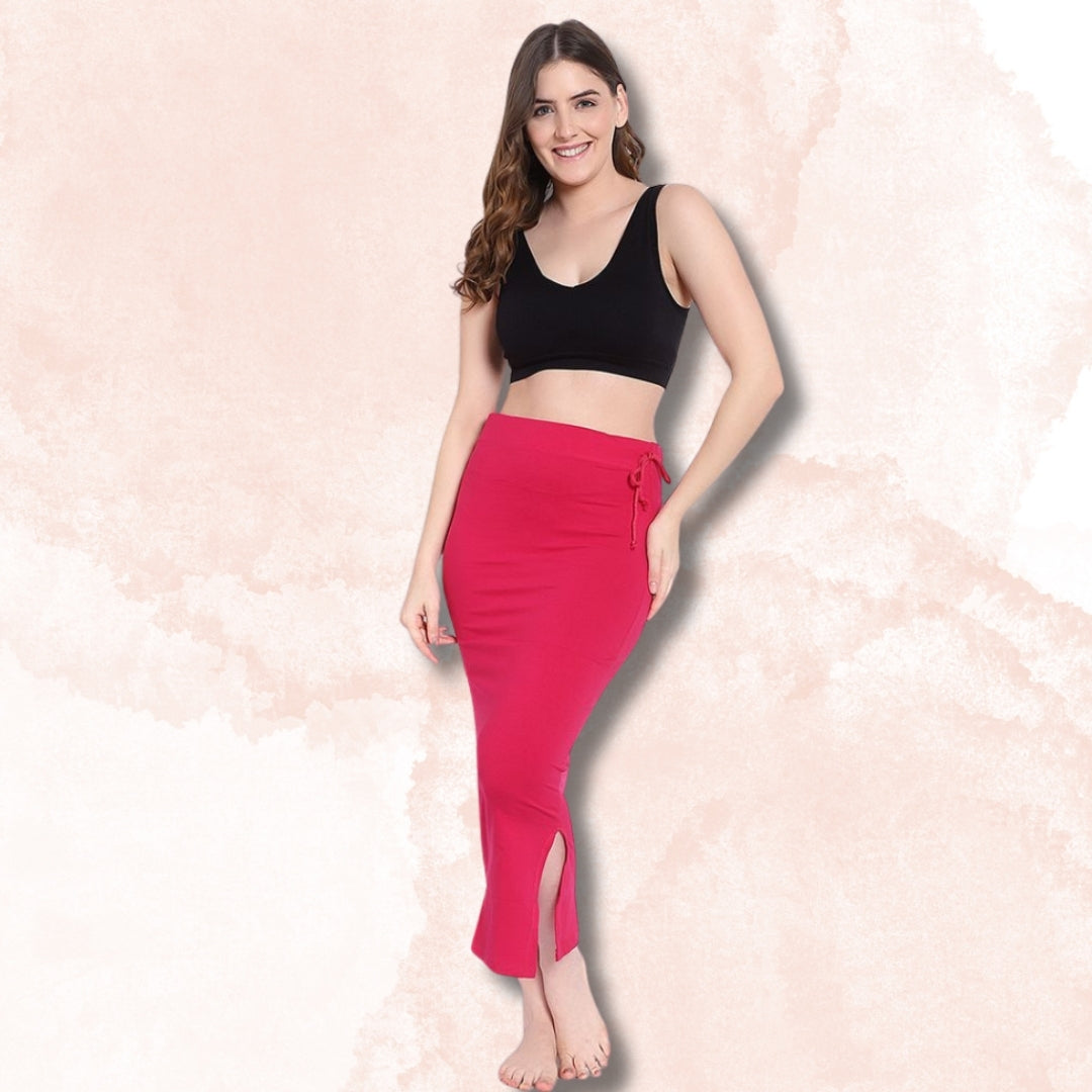 "Woman wearing a black sports bra and red pants on a light pink background by brachy"