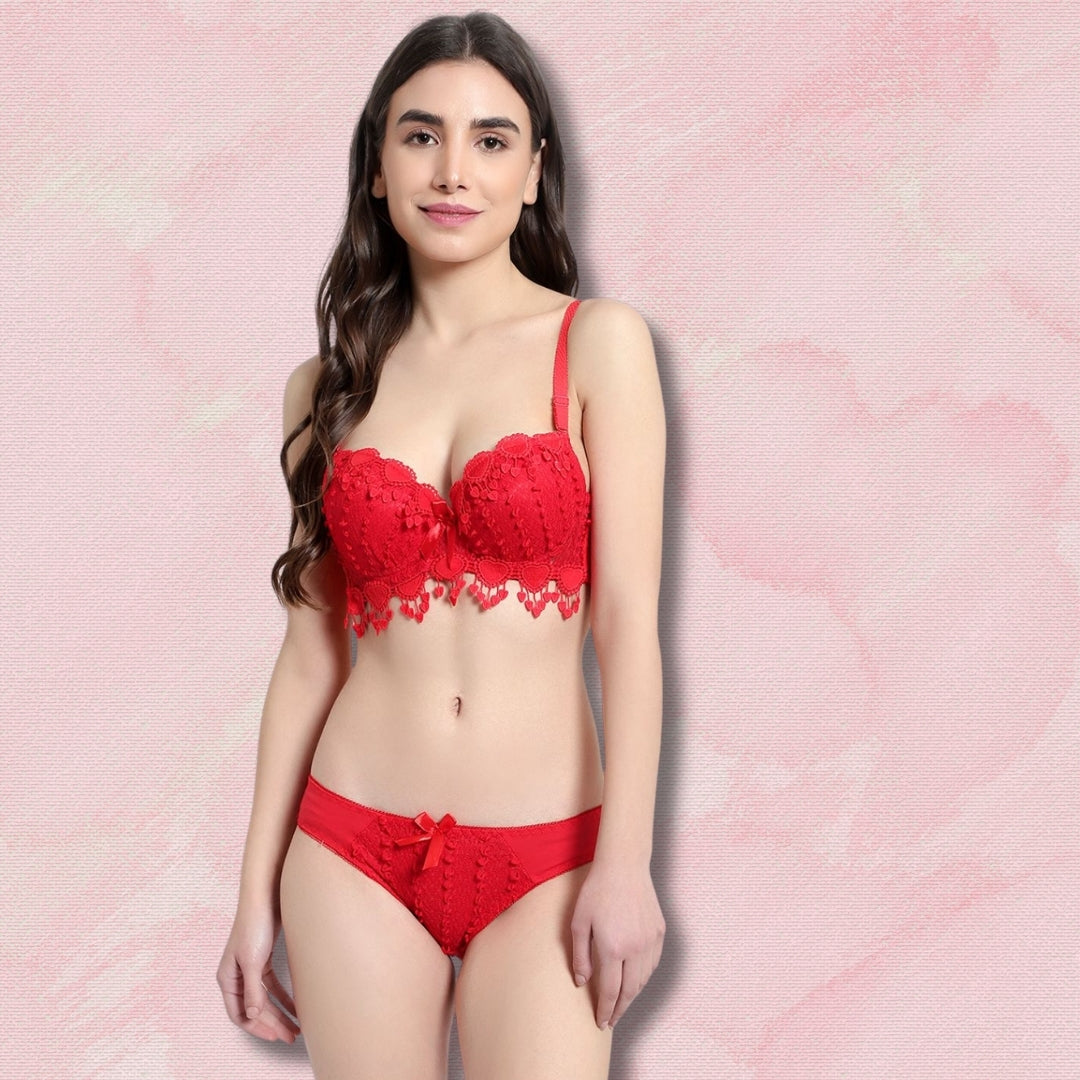 "Woman wearing a red lace lingerie set on a pink background by brachy"